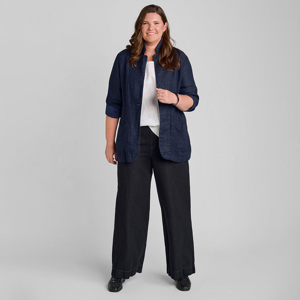 Woman in blue linen/cotton blend blazer, white linen under shirt, and black linen/cotton blend pants
