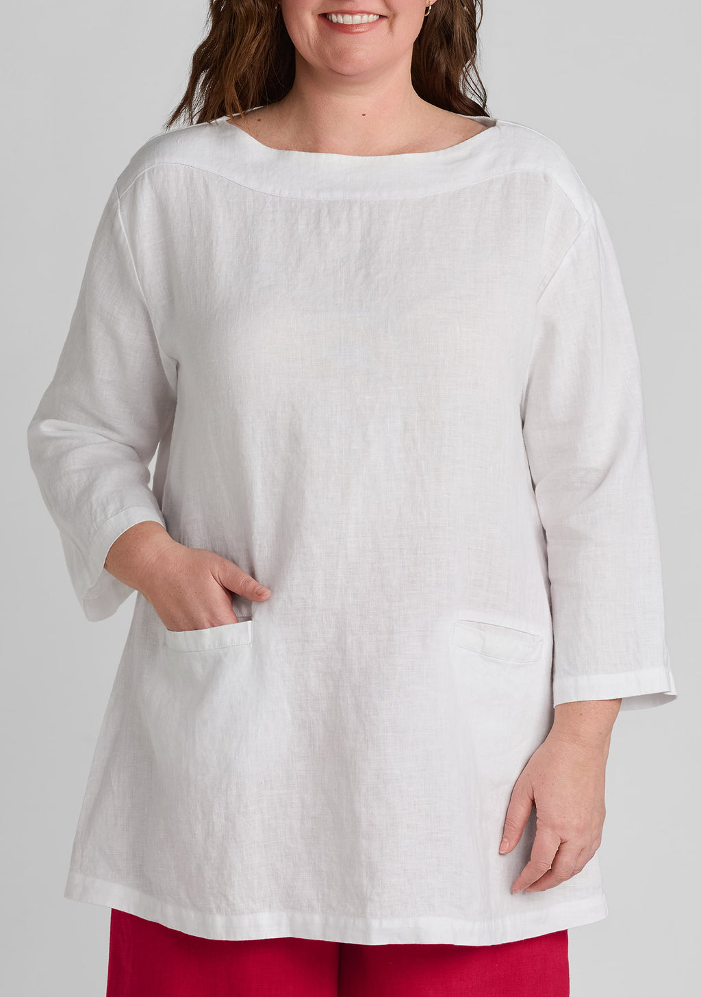close up image of women's white linen shirt showing pockets and seaming details
