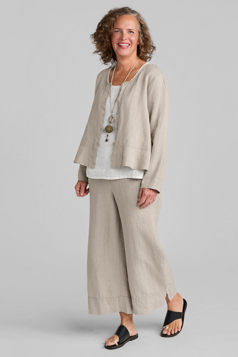 Woman in beige linen pants and beige linen shirt