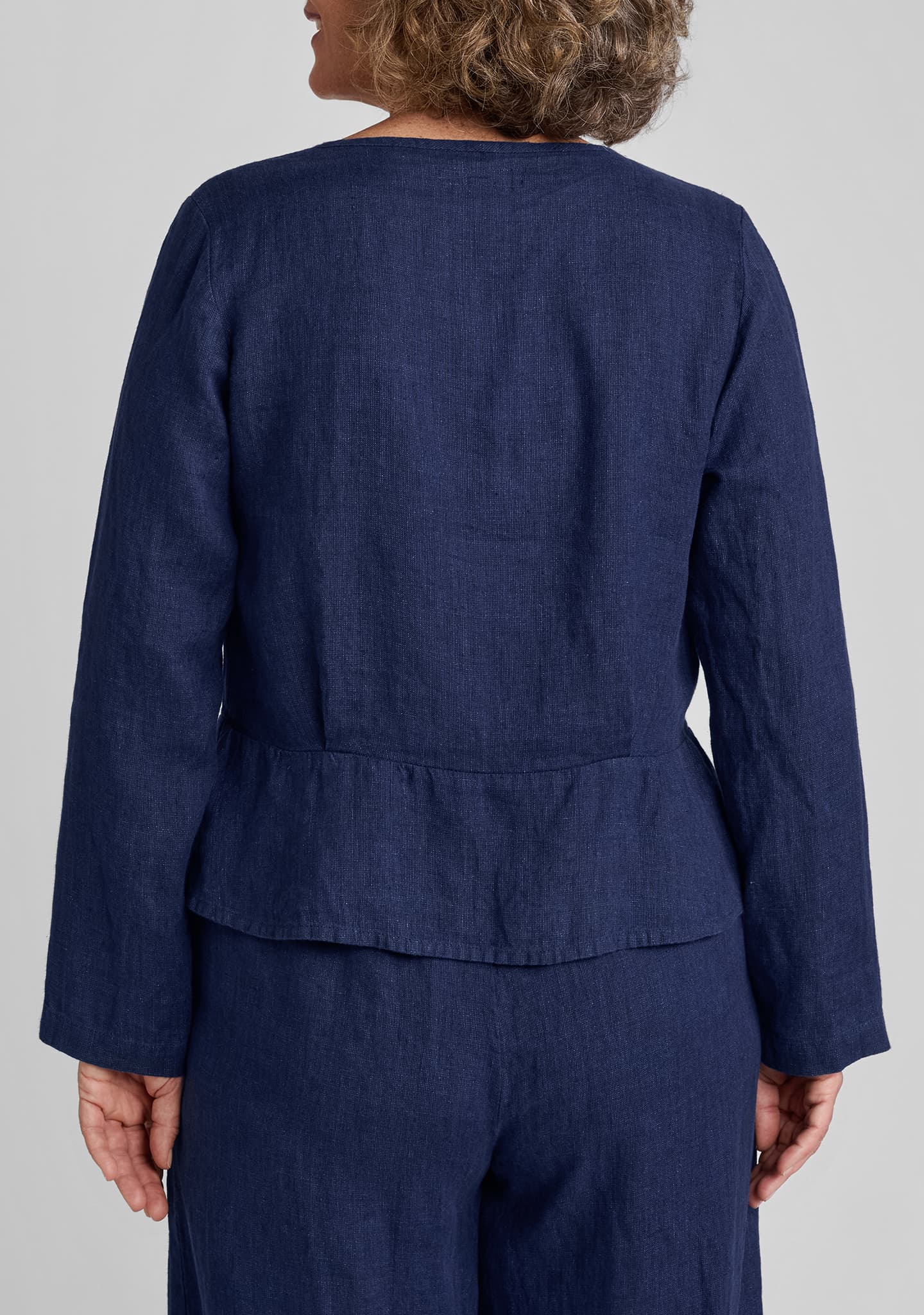 back view of peplum pullover in blue