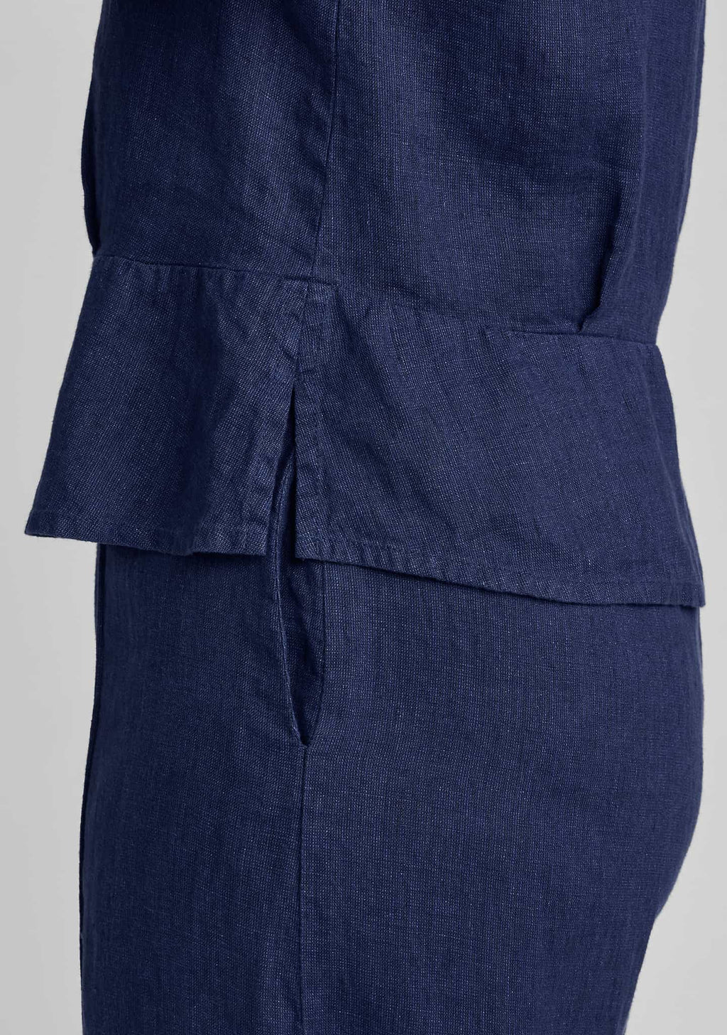 side view of peplum pullover in blue