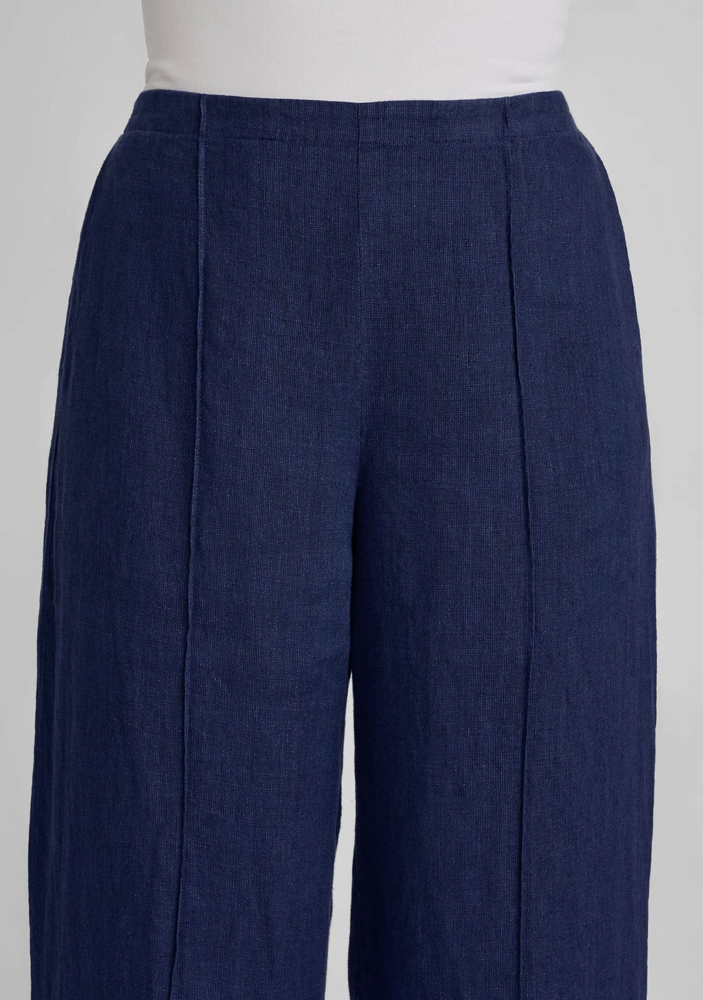 close up view of pintuck details and flat front waist on pant