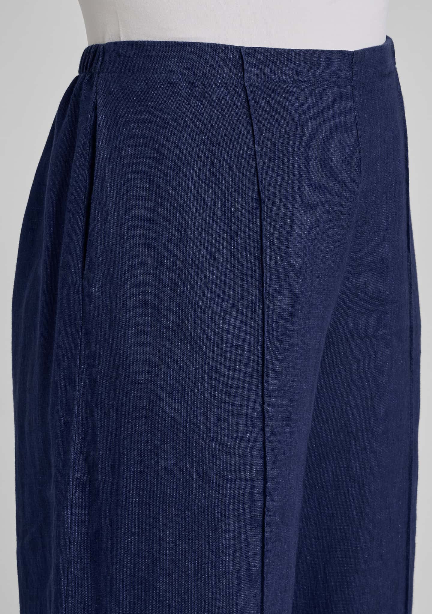 close-up of dark navy blue pleated trousers