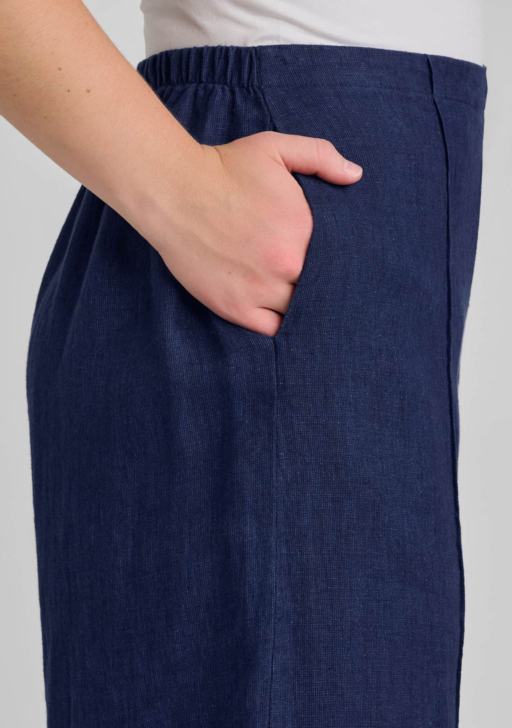 hand in pocket on blue linen pants