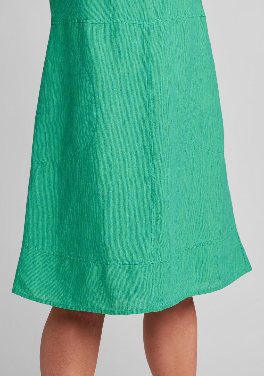 close up of seaming details on women's linen dress in green