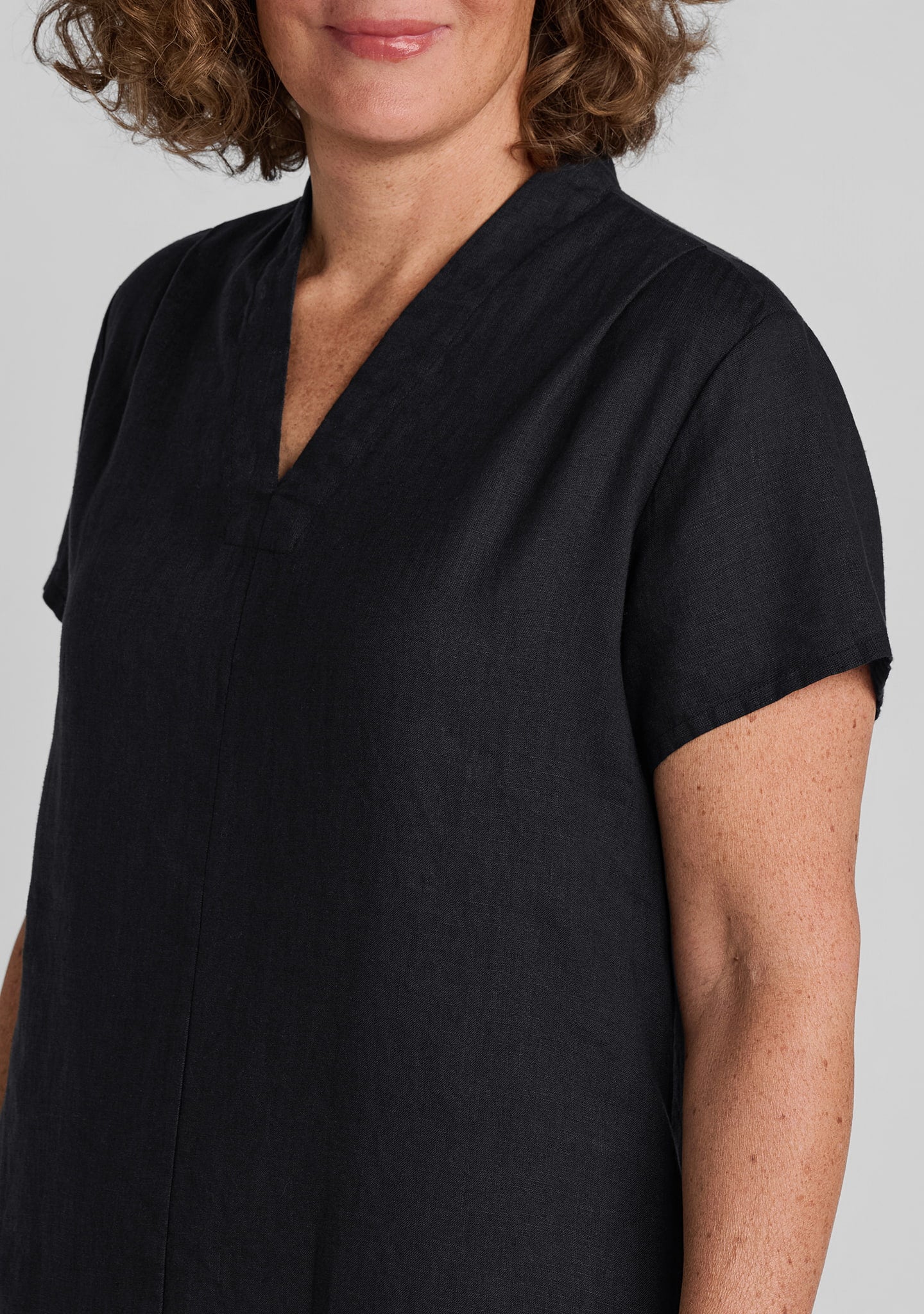 shoulder view of women's black linen dress