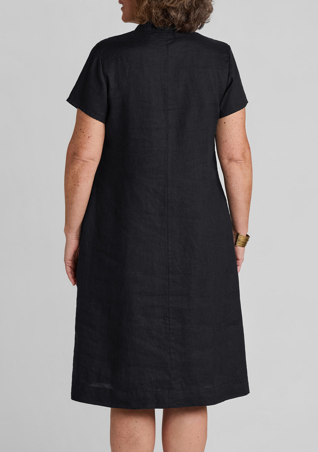 close up back view of women's black linen dress