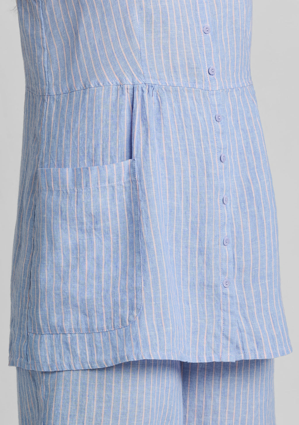 close up image of pocket and seam details on blue linen top
