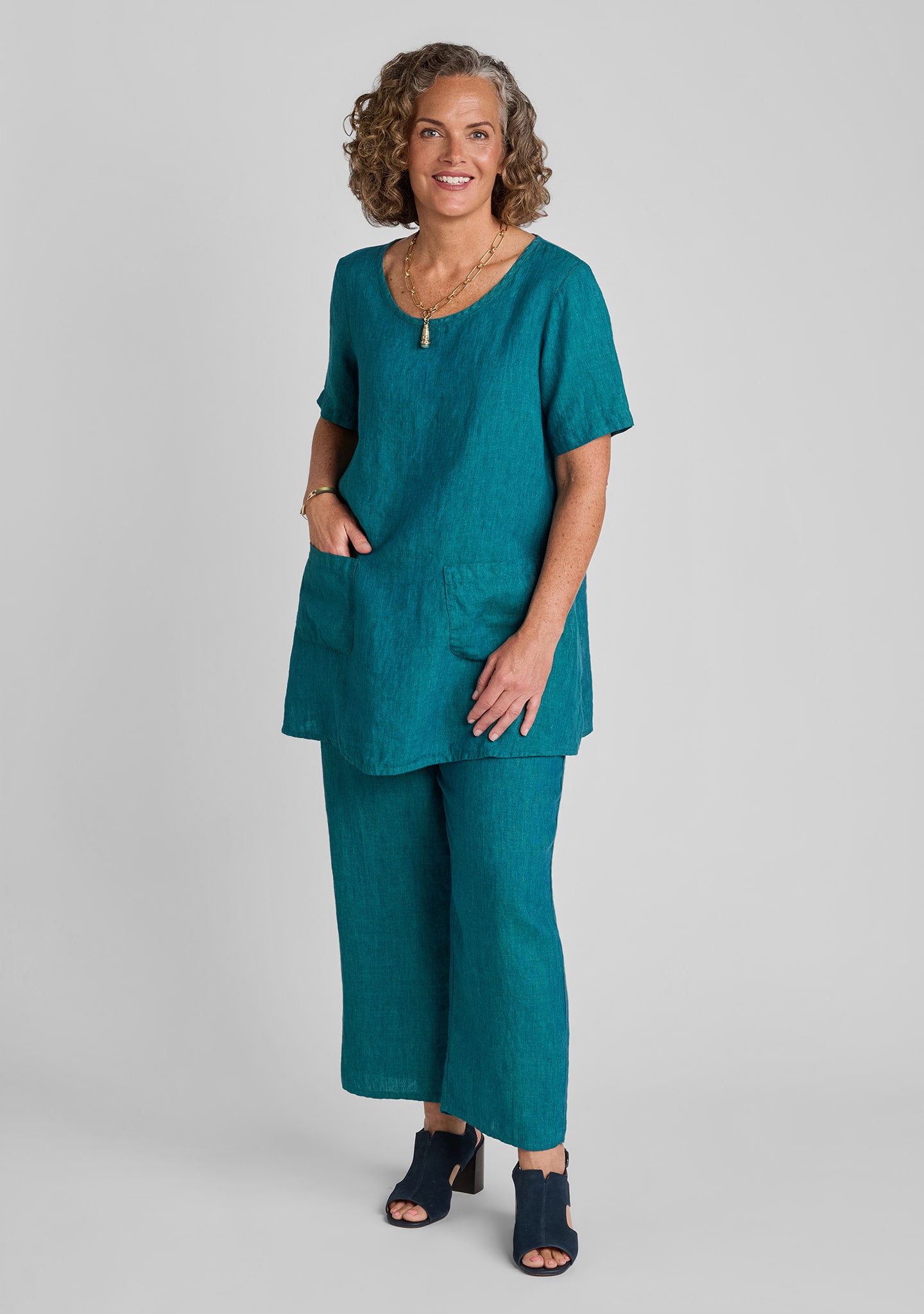woman modeling a matching green t shirt and pants set