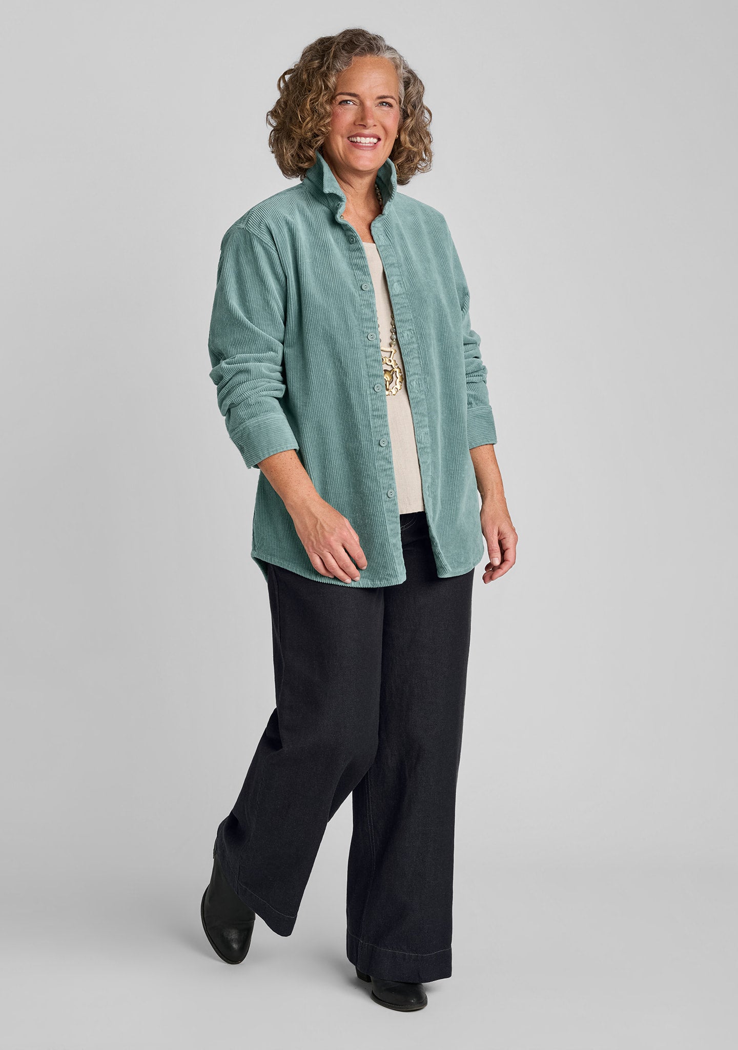 woman wearing blue corduroy shirt with natural shirt and denim pants