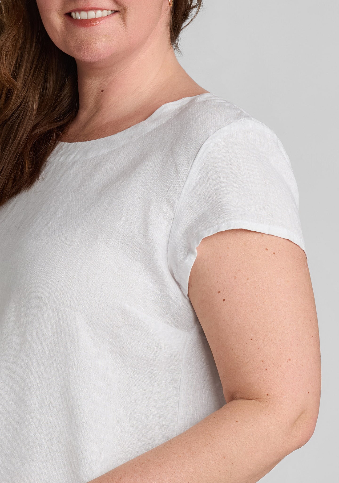 shoulder view of women's linen tee shirt in white