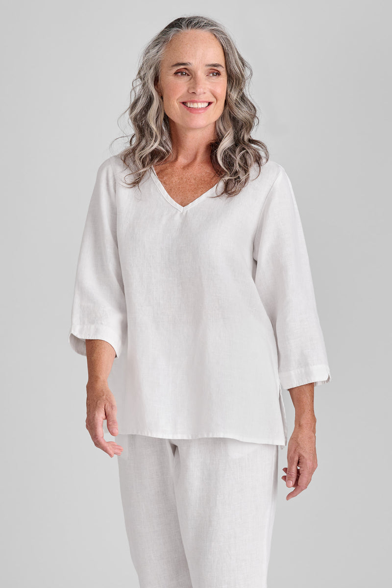 Woman in white linen shirt and white linen pants