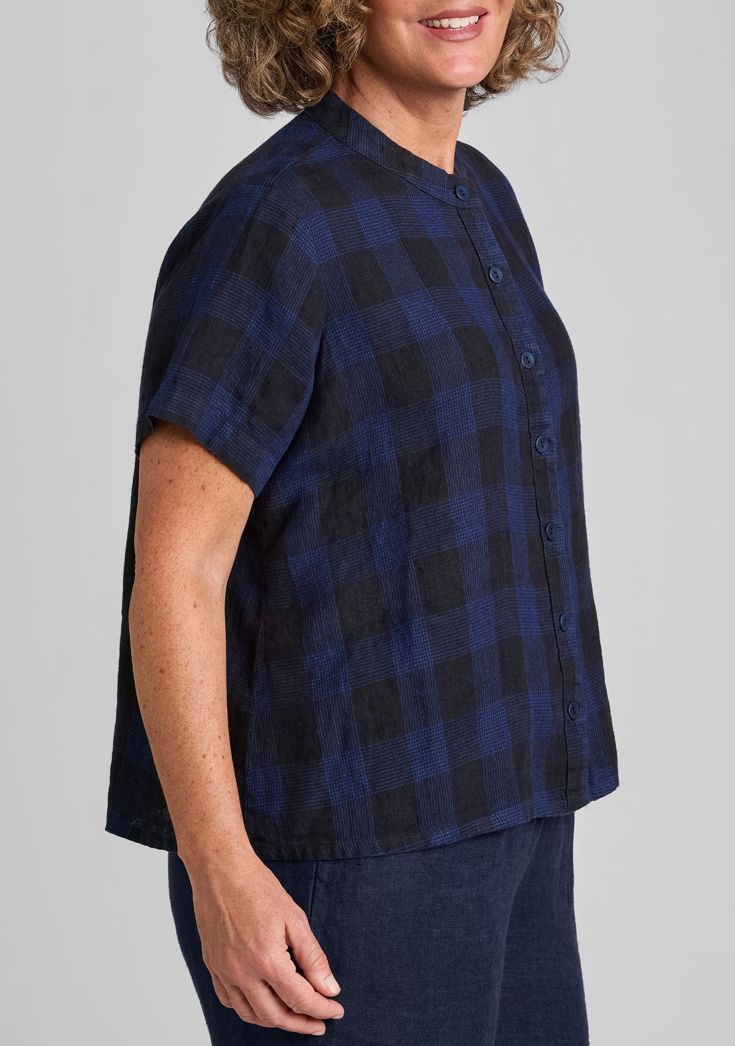 side view of a blue paid button down shirt